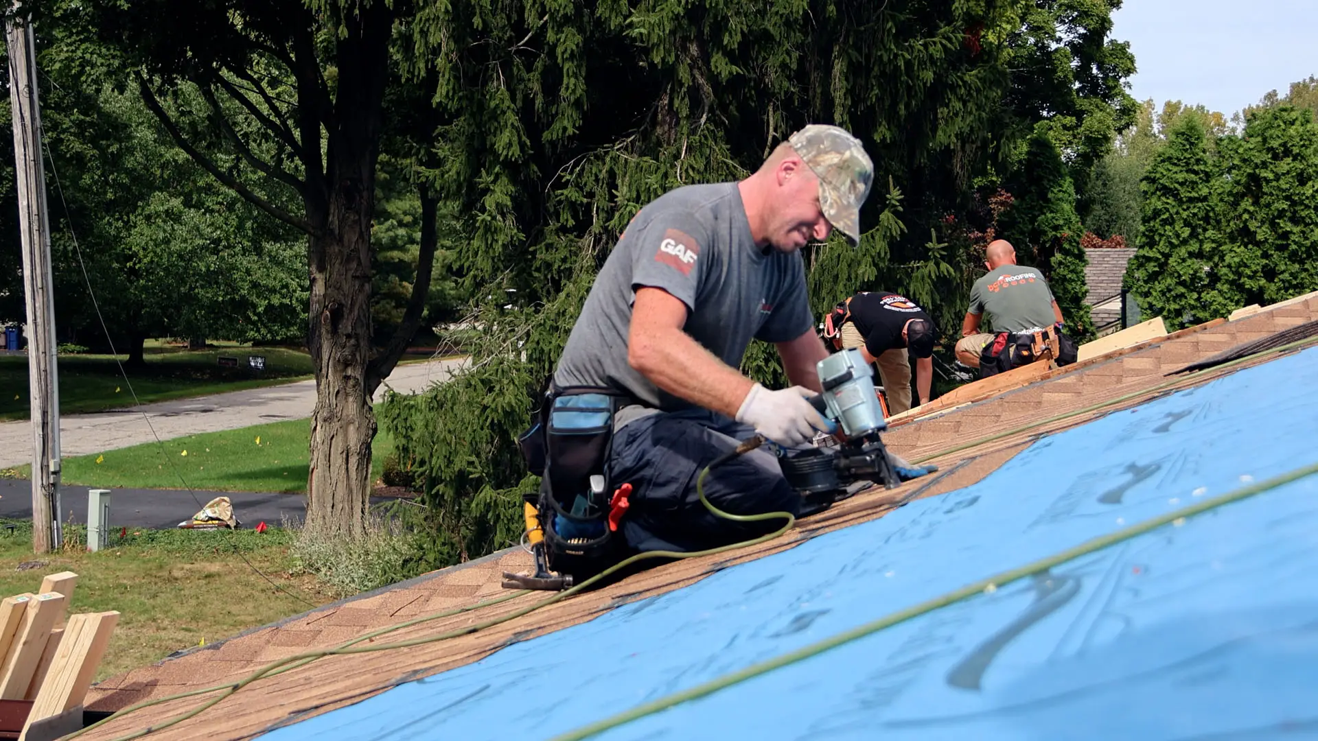 Professional roofing crew installing asphalt shingles